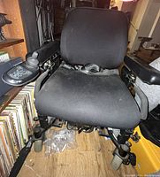 Front view of black fabric seat and joystick control armrest