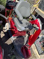 Side view of red Rascal 600T showing seat, foot platform and rear wheels