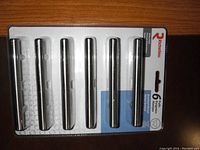 Single sealed package of six brushed nickel cabinet pulls by Richelieu with product label and visible product.