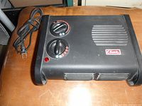 Top and side view of the Classic heater with control dials, indicator light and ventilation grills showing plastic housing and branding.