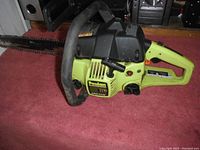 Side angle of Poulan 2150 gas chainsaw showing body, handle, and cutting bar with chain.