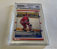 Front image of Eric Lindros rookie hockey card graded Gem Mint 10 by Pinnacle 1994-95 showing him skating on ice in red uniform.