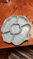 Full view of the light blue vintage divided serving platter shaped like petals with a center flower compartment, made by Doranne.