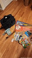 Overview of bag, phone, pennants, comics, and other items in lot