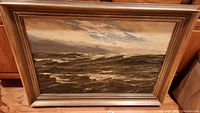 Full view of framed painting showing stormy ocean scene
