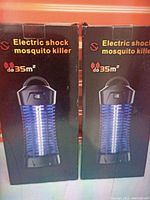 Photo of two boxed electric shock mosquito killers showing packaging and coverage area up to 35m².
