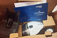 Open box showing Holife branded car vacuum, charging base, and VIP upgrade card