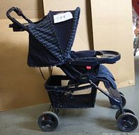 Side view of COSCO stroller showing frame, canopy, wheels, and storage basket