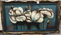 Front view of framed signed print with white flower motif on blue and brown background.