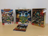 Three incomplete LEGO boxed game sets: Race 3000, Minotaurus, Heroica with Star Wars booklet.