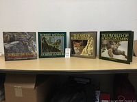 Four Robert Bateman art books displayed on a table, showing front covers and size comparison.