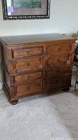 Front view of wooden Hickory White dresser with six dovetail drawers, showing metal pull handles and carved drawer faces.