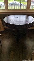 Full top view of the round table showing the faux leather-look top under natural lighting