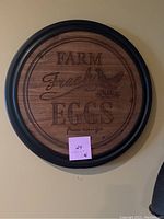 Round wooden Farm Fresh Eggs sign with black frame