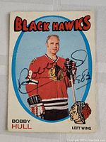 Front of the hockey card showing Bobby Hull in Black Hawks jersey with autograph