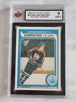 Front view of the graded Wayne Gretzky card showing player in Edmonton Oilers uniform, card details, and PSA grading label with Mint 9 grade.