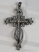 Front view of the Art Nouveau style cross pendant showing intricate filigree and rhinestone detail