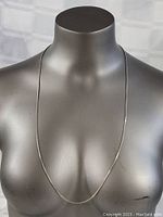 Full view of the sterling silver box chain necklace displayed on a mannequin.