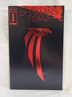 Front cover of Shaman's Tears #1 comic book showing black background with red symbolic eye and title in red lettering