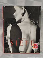 Front cover of the coffee table book featuring a black and white portrait of a woman with an elegant back pose and jewelry, titled 'Jeanloup Sieff' published by Taschen.