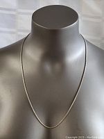 Full view of sterling silver box chain necklace displayed on mannequin showing length and condition.
