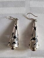 Pair of vintage sterling silver cone-shaped earrings with intricate cut-out patterns and rounded bead at the tip
