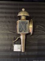 Full side view of the brass carriage lamp showing the beveled glass panels and the mounting bracket.