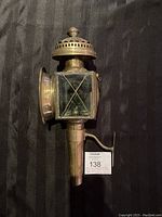 Front and left side view of Edwardian brass carriage lamp showing beveled glass and brass mount