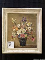 Full view of the framed painting showing a still life floral arrangement in a dark vase, with visible artist signature.