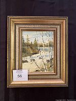 Full view of the framed original oil painting showing a winter landscape with a river, trees, and snow.