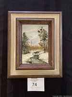 Full view of the framed original painting depicting a winter landscape with a bench and trees.