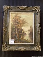 Full view of the original painting showing the lakeside landscape and elaborate frame.