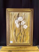 Full view of the framed original painting with white flowers on a golden background.