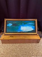 Framed vintage Niagara Falls motion art display unlit showing painted waterfall scene within wooden base.