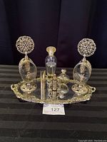 Full view of the vintage perfume set on brass mirror tray showing two perfume bottles and atomizer.