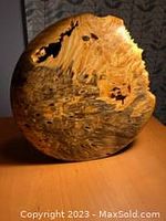 Image showing the large hand-turned wooden vase from front with visible natural voids and grain variations on surface