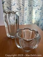 Pair of clear Orrefors crystal vases with petal-shaped tops, shown standing and laying down