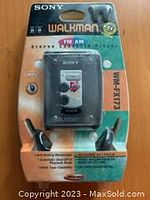 Full view of Sony Walkman WM-FX173 in original blister packaging with product details and headphones visible