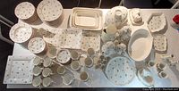 Overhead view of entire set showing plates, bowls, platters, cups and serving pieces laid out