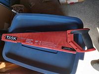 Full view of the TASK Tools 22 inch hand saw with handle and blade cover visible.