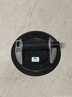 CRL Sure-Grip 8 inch vacuum lifter with rubber suction pad and central handle, photographed on a concrete floor.