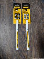 Two packs of DeWalt 12 inch hack saw blades, each pack has two blades attached to yellow and black packaging with specs visible.
