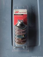 Clear image of the seven 2-inch sanding discs stacked and packaged with Ingersoll Rand branding and included metal sanding pad and spindle attachment.
