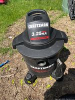 Front view of Craftsman wet/dry vacuum showing branding and model details with 8 gallon tank base and wheels.