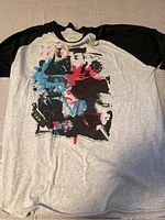Front view of concert T-shirt showing full graphic and design colors.