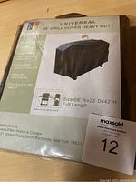 Package showing brand CPP, Universal 68" Grill Cover Heavy Duty, with features like vinyl-coated material, secure fit, size dimensions 68" W x 23" D x 42" H, full length.