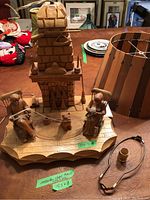 Overall view of carved lamp base with cabin, couple, cat, and detached lamp shade