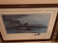 Frontal view of framed duck print showing two wood ducks on water