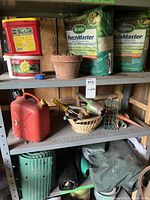 Shelf with fertilizers (Miracle-Gro, All Purpose), bags of Scotts PatchMaster seed and fertilizer, terracotta pot with peat pellets, and small plastic gas cans at the bottom