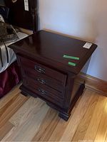 Front view of one bedside table showing finish and hardware